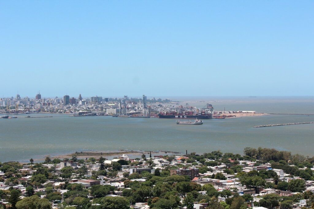 Photo by Tania Malréchauffé a large body of water with a city in the background