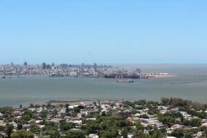 a large body of water with a city in the background