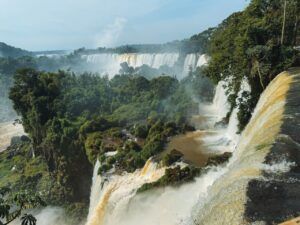 Breathtaking view of Iguazu Falls surrounded by lush rainforest in Puerto Iguazu, Argentina.