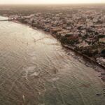 Stunning aerial view of Playa del Carmen coastline at dusk with cityscape and beachfront.