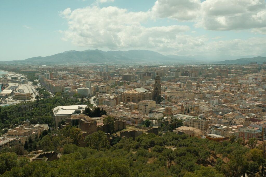 A breathtaking aerial view of Málaga, Spain, showcasing the city's historic architecture and surrounding landscape.