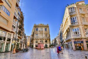 Street view in Cartagena, Spain showcasing classic architecture and bustling atmosphere.